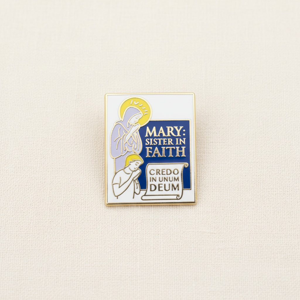 A enamel pilgrim badge featuring an illustration of Mary and a child with the inscription 'MARY: Sister in Faith' and 'CREDO IN UNUM DEUM'.