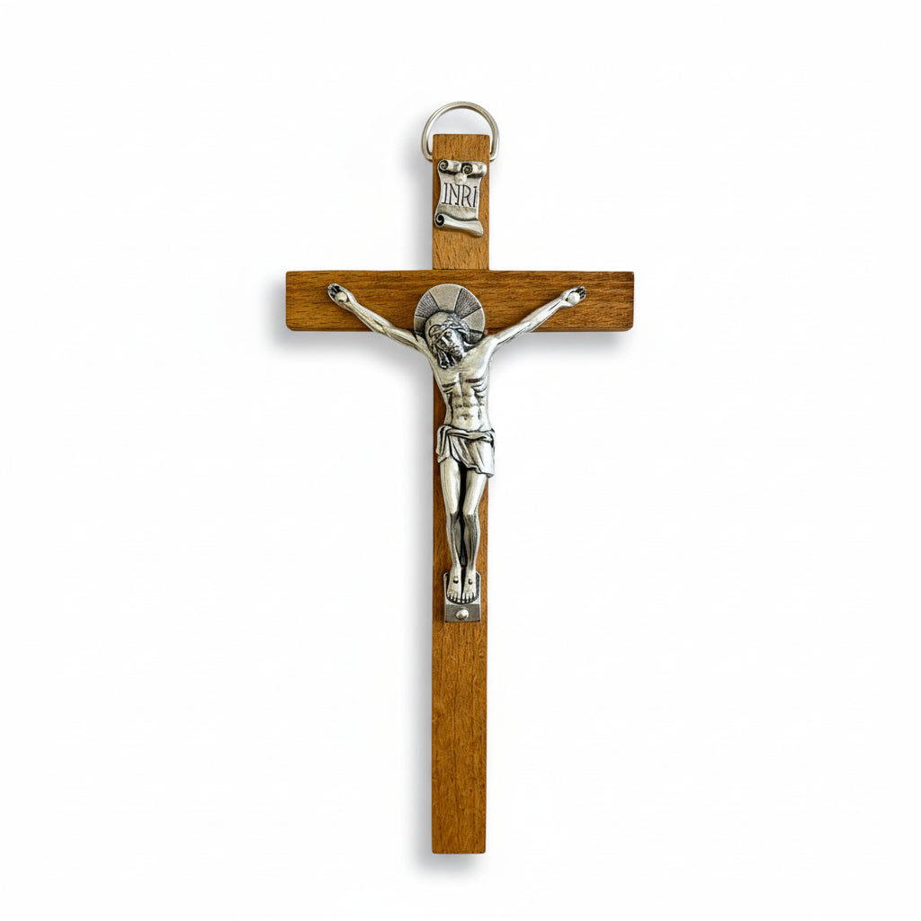 A wooden crucifix with a silver-colored figure of Jesus Christ in the center, designed for wall hanging.