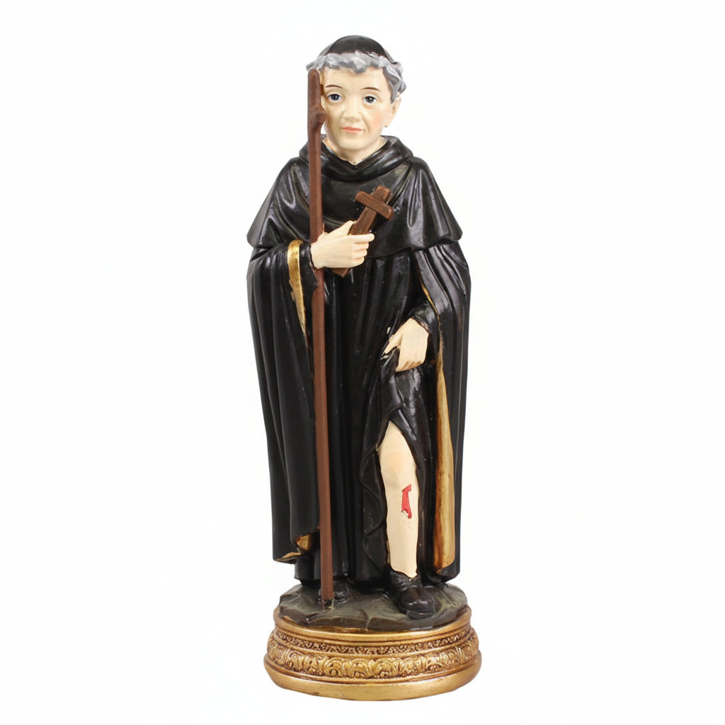 A black resin statue of St. Peregrine, the patron saint of cancer patients, wearing a monk's outfit and holding a cross.