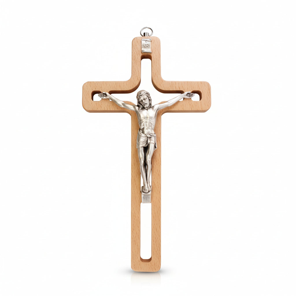 A beech wood cross with a cut out shape, featuring a metal corpus of a crucified figure, singly boxed.