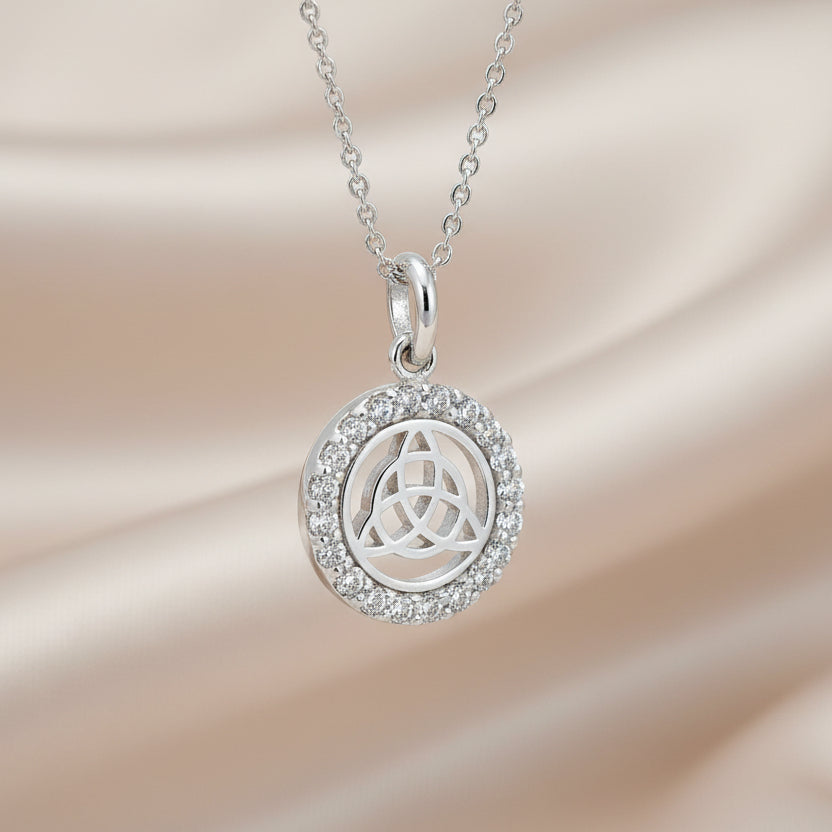 A silver necklace pendant featuring a Celtic Trinity Knot design with cubic zirconia.