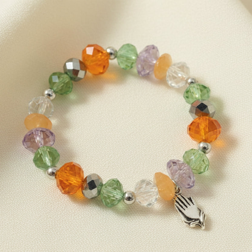 A colorful glass bracelet displayed on a card with the text 'Friendship' and a butterfly motif.