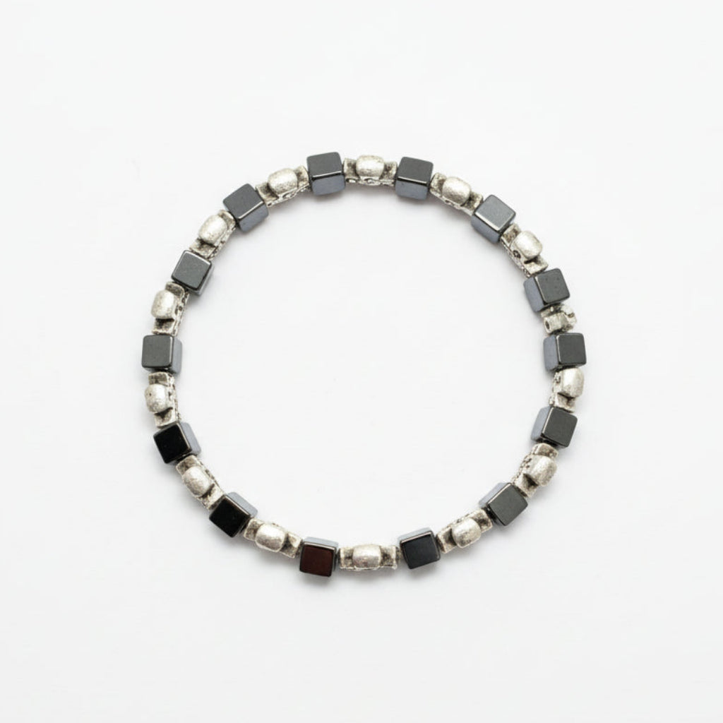 Bracelet with black and silver beads on a white surface