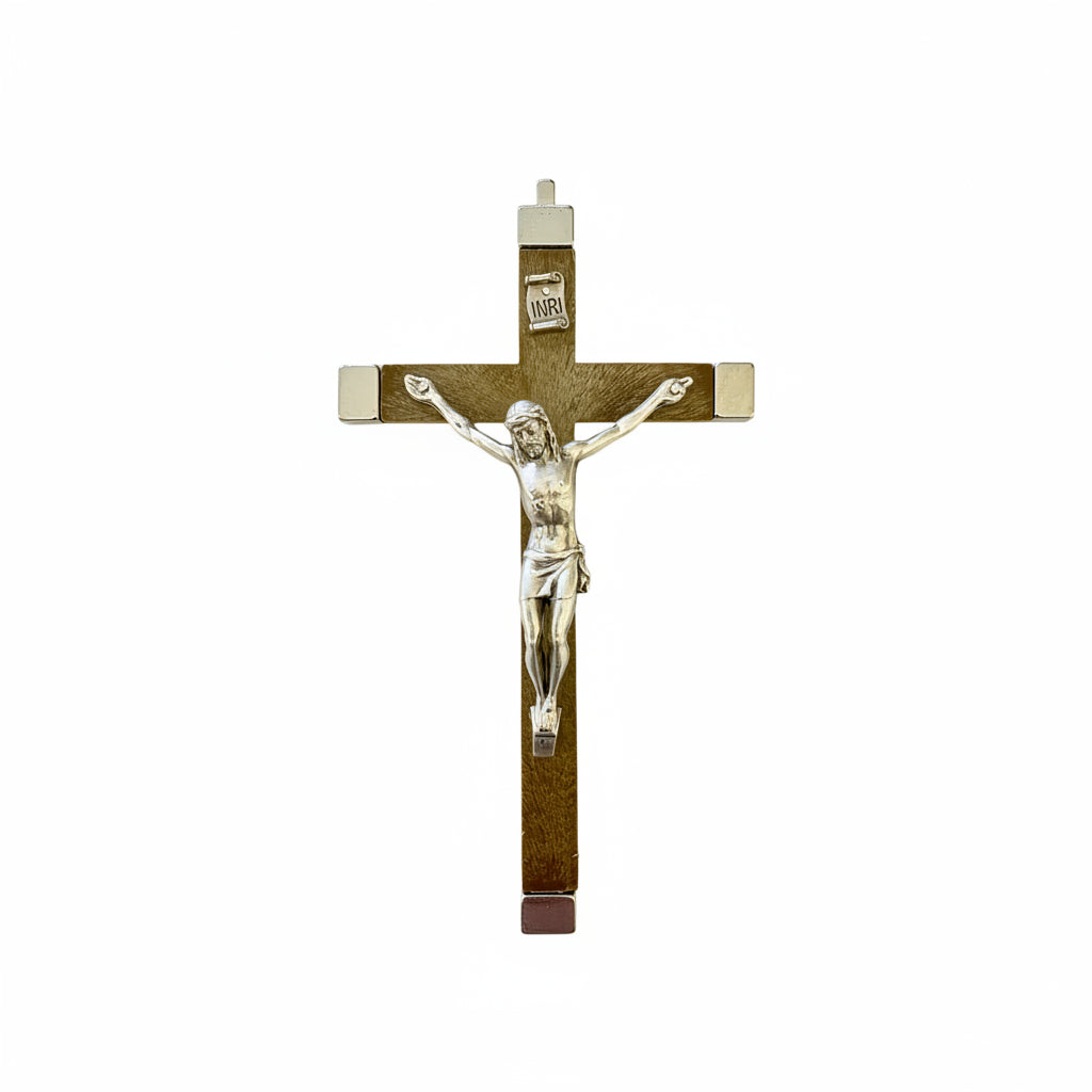 A silver-colored metal hanging wall crucifix with a representation of Jesus Christ on the cross.