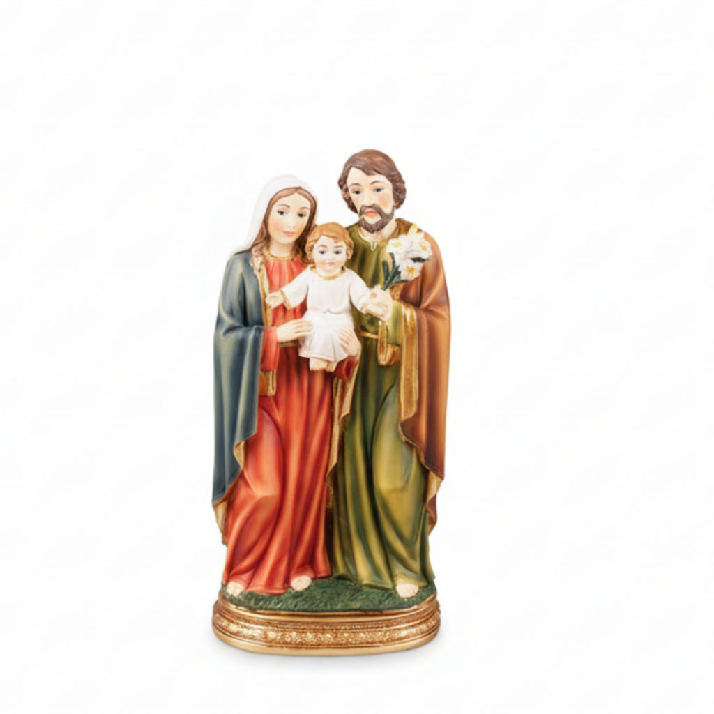 A colorful resin statue of the Holy Family, featuring the figures of Mary, Joseph, baby Jesus, and an angel.