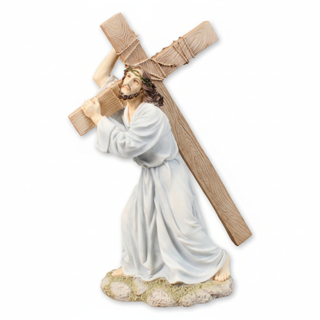 A resin statue of Jesus carrying a cross, predominantly beige and white colors, with a stylized artistic inspiration.