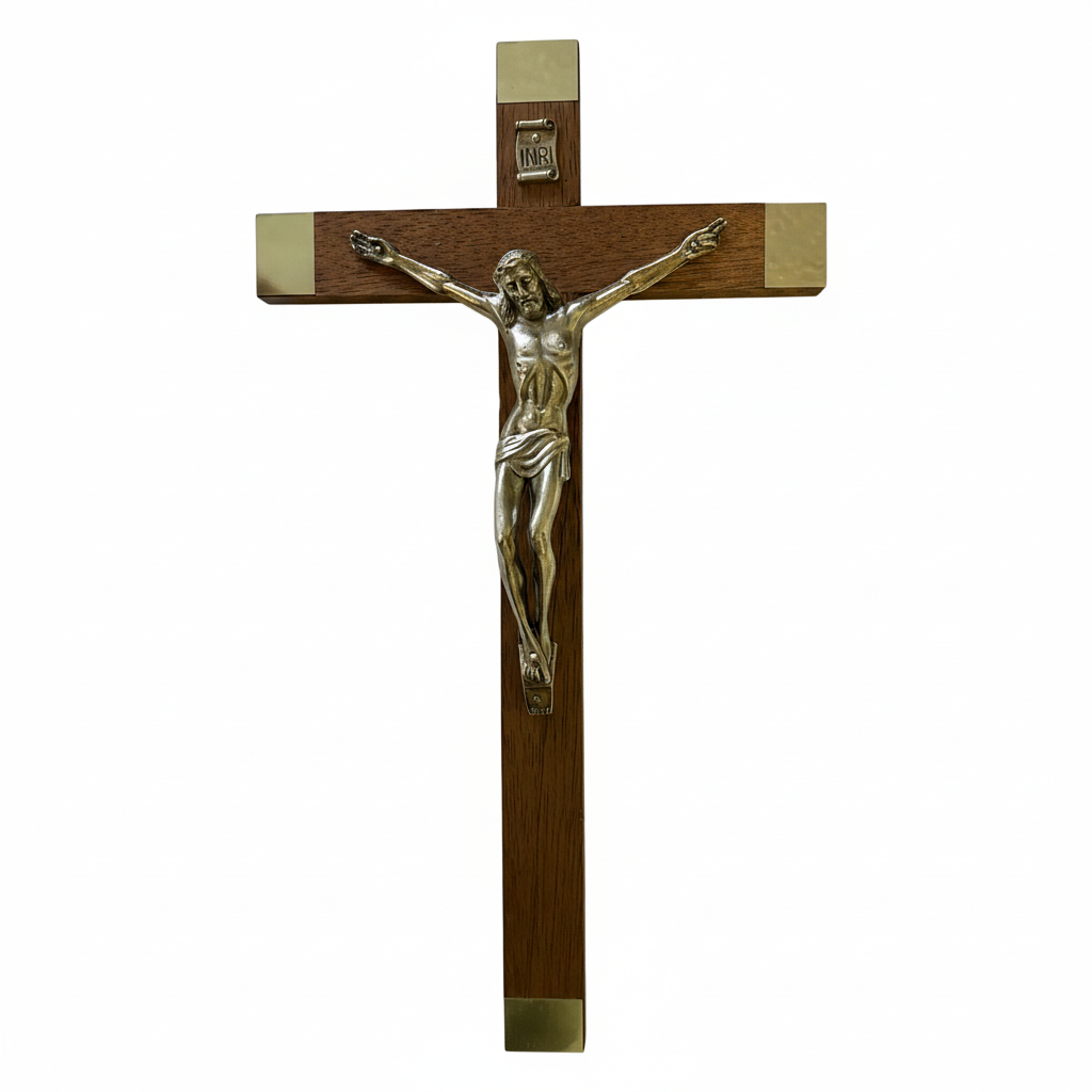 A hanging crucifix with a light wood cross and a gold-tipped depiction of Jesus Christ.