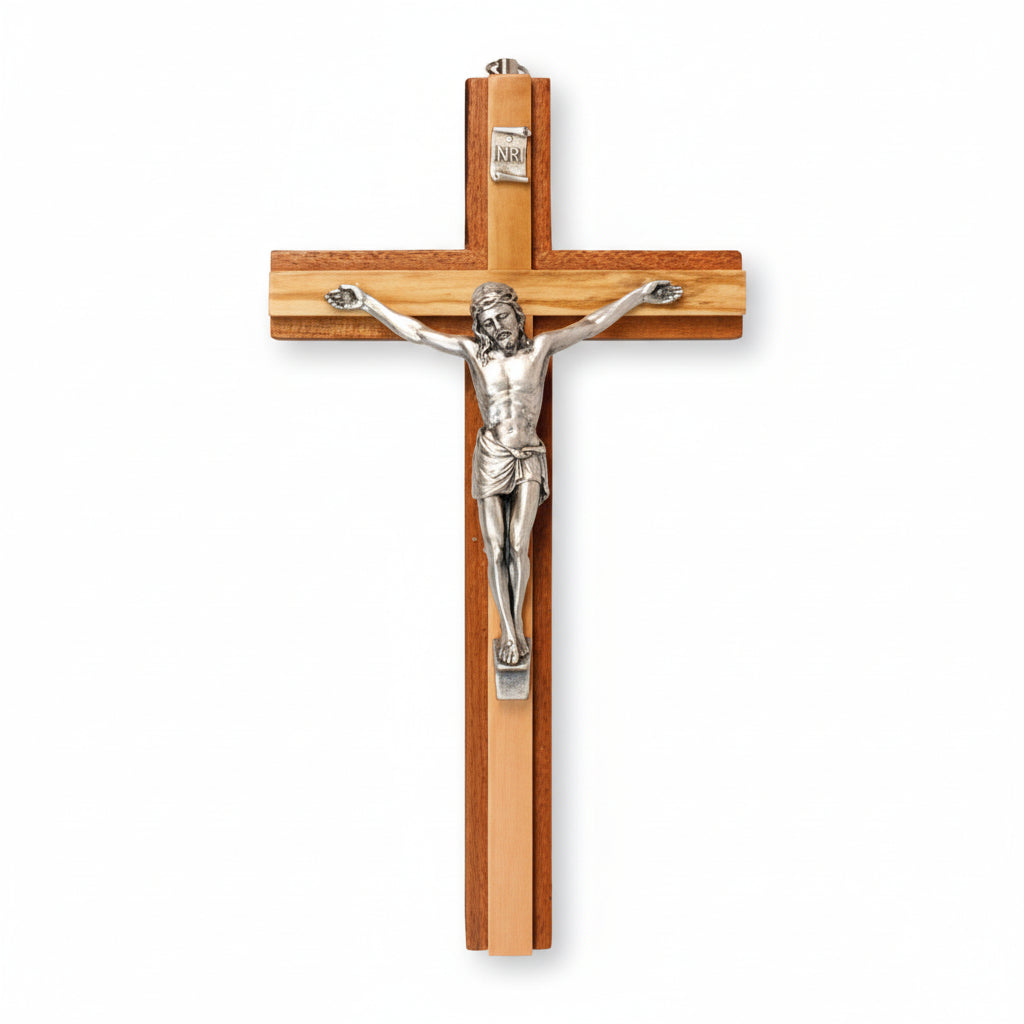 A 6 inch mahogany wood crucifix with a metal corpus, having an olive wood insert at the center.