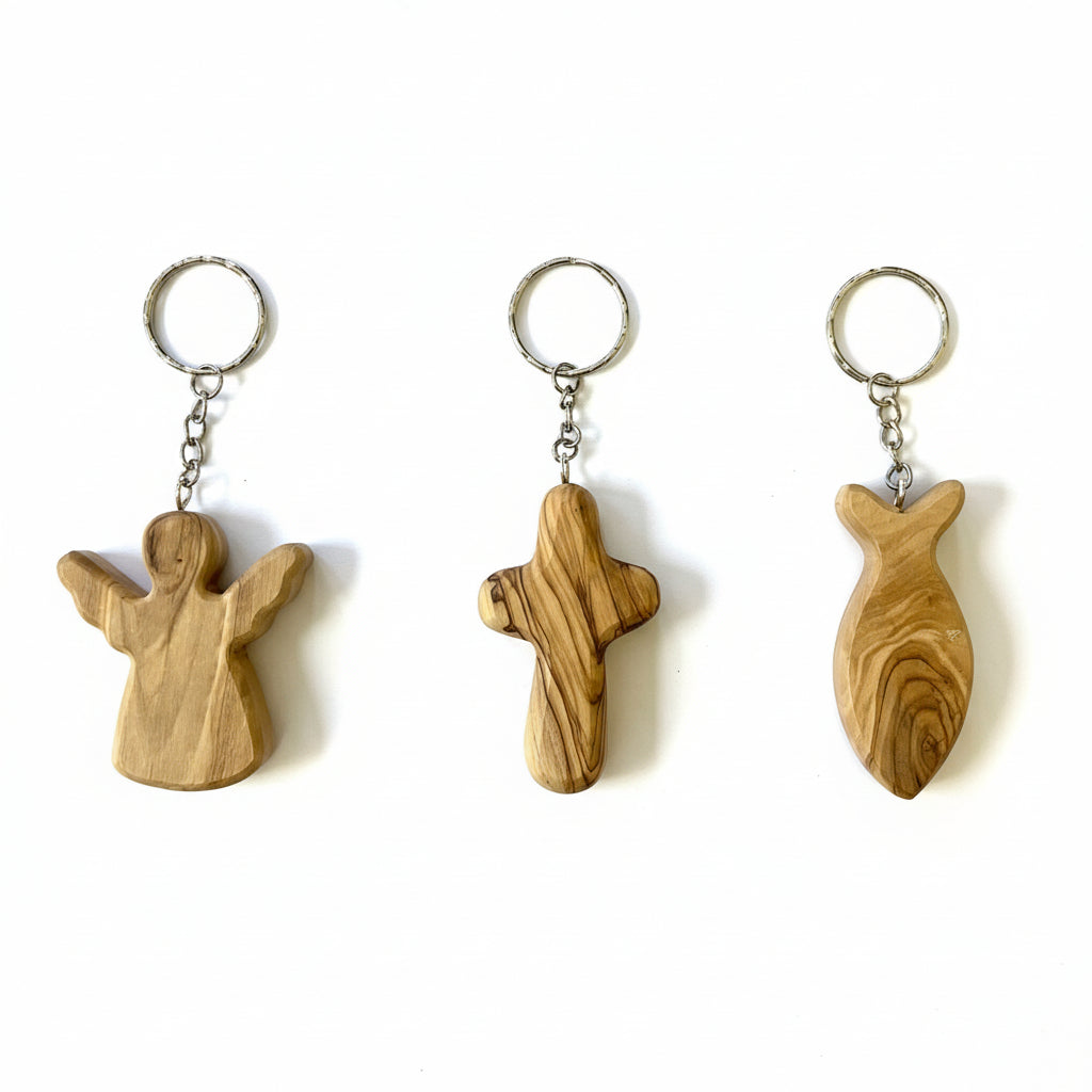 Three wooden keyrings with engraved designs, displayed against a white background.