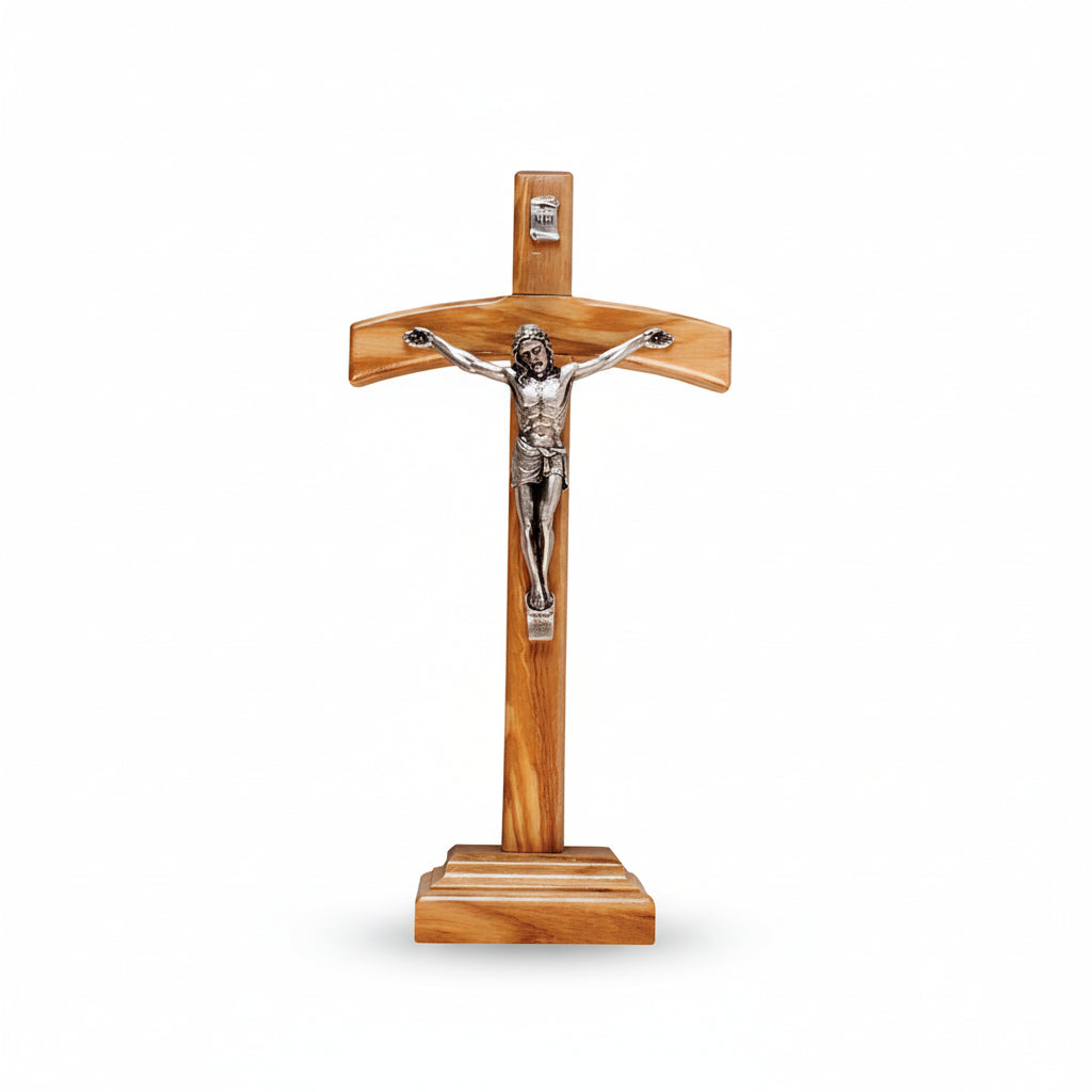 Wooden cross with a silver Jesus figure on a white background