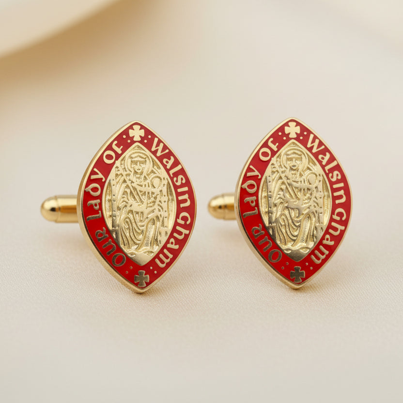 Two red and gold emblem pins on a black background