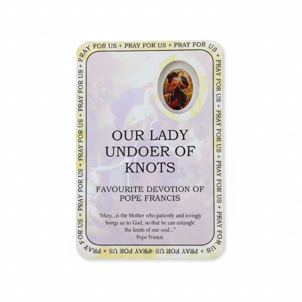 Card featuring 'Our Lady of Undoer of Knots' devotion on a wooden surface