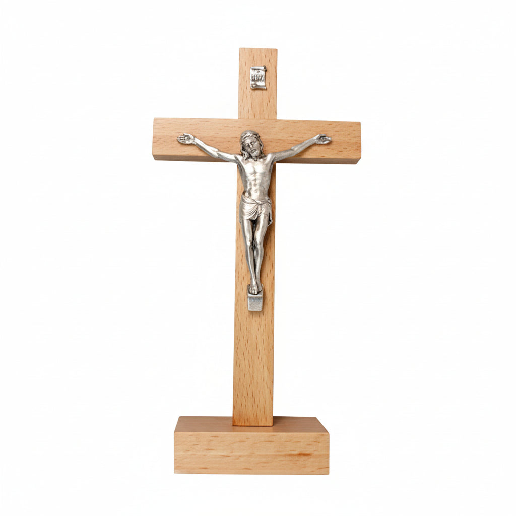 A wooden standing crucifix with a metal representation of Jesus Christ on the cross.