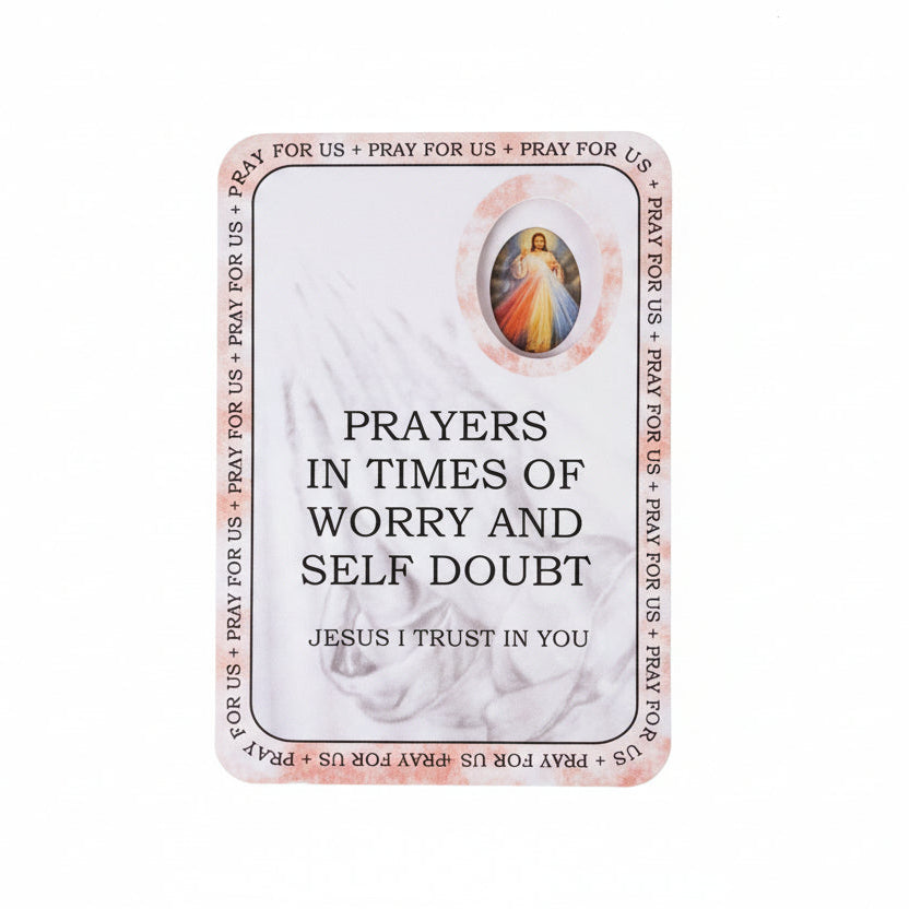 Prayer card with text and a religious symbol on a wooden surface