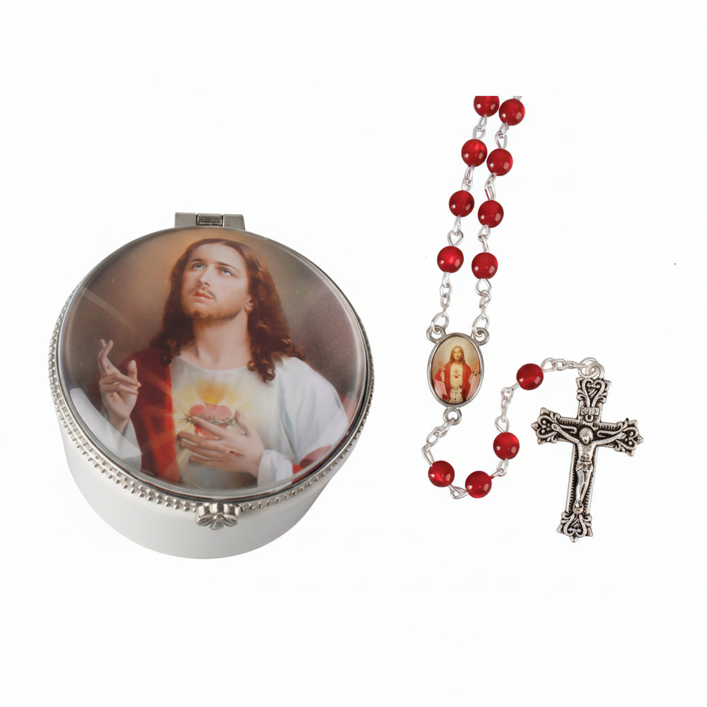 Compact mirror with religious design and rosary on a gray background