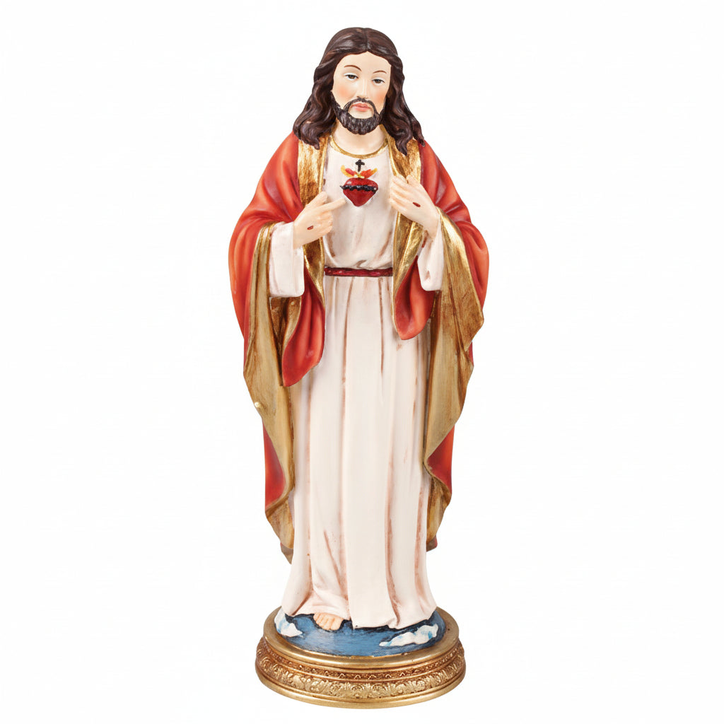 A resin statue of the Sacred Heart of Jesus, predominantly red and gold in color, with a white robe. The statue is depicts Jesus holding a heart symbol.