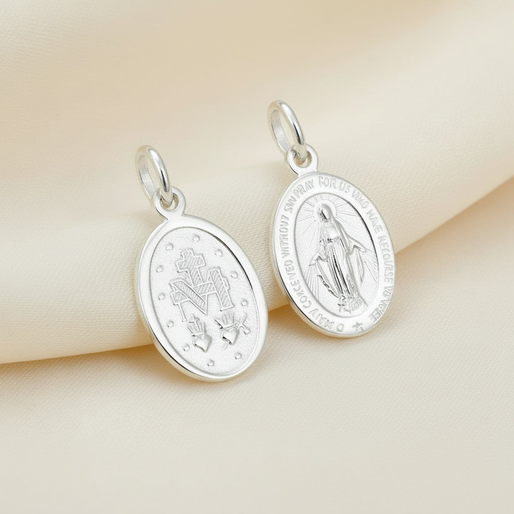 Two silver religious pendants on a white background