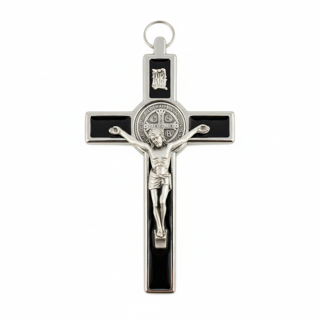 A metal crucifix featuring an image of Jesus Christ on the cross, with a black and gold color scheme.