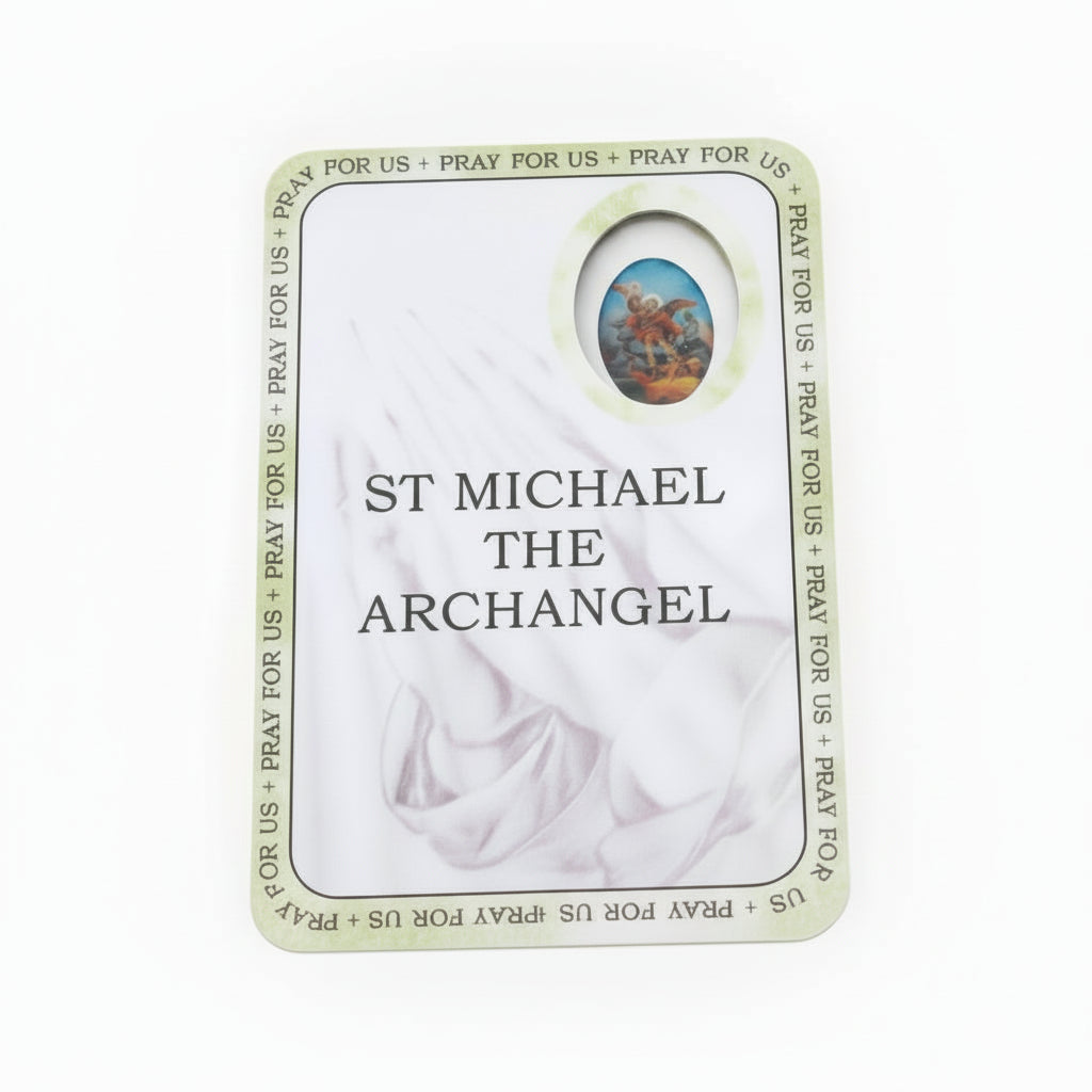 Card featuring St. Michael the Archangel with religious text on a wooden surface