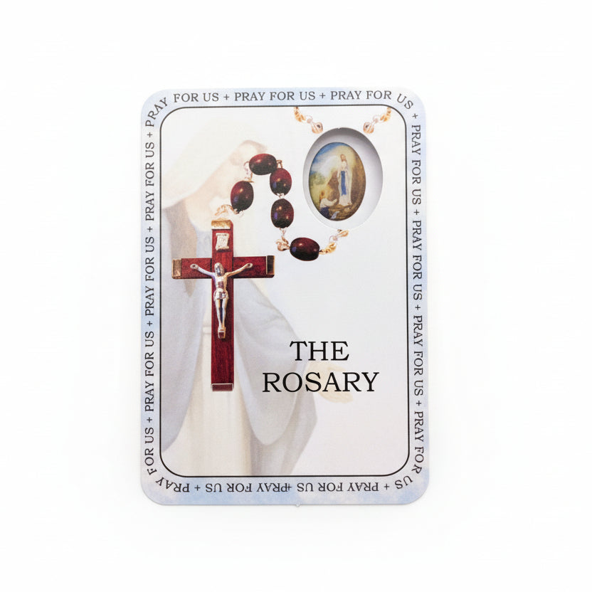 Card featuring images of a rosary and cross on a wooden surface
