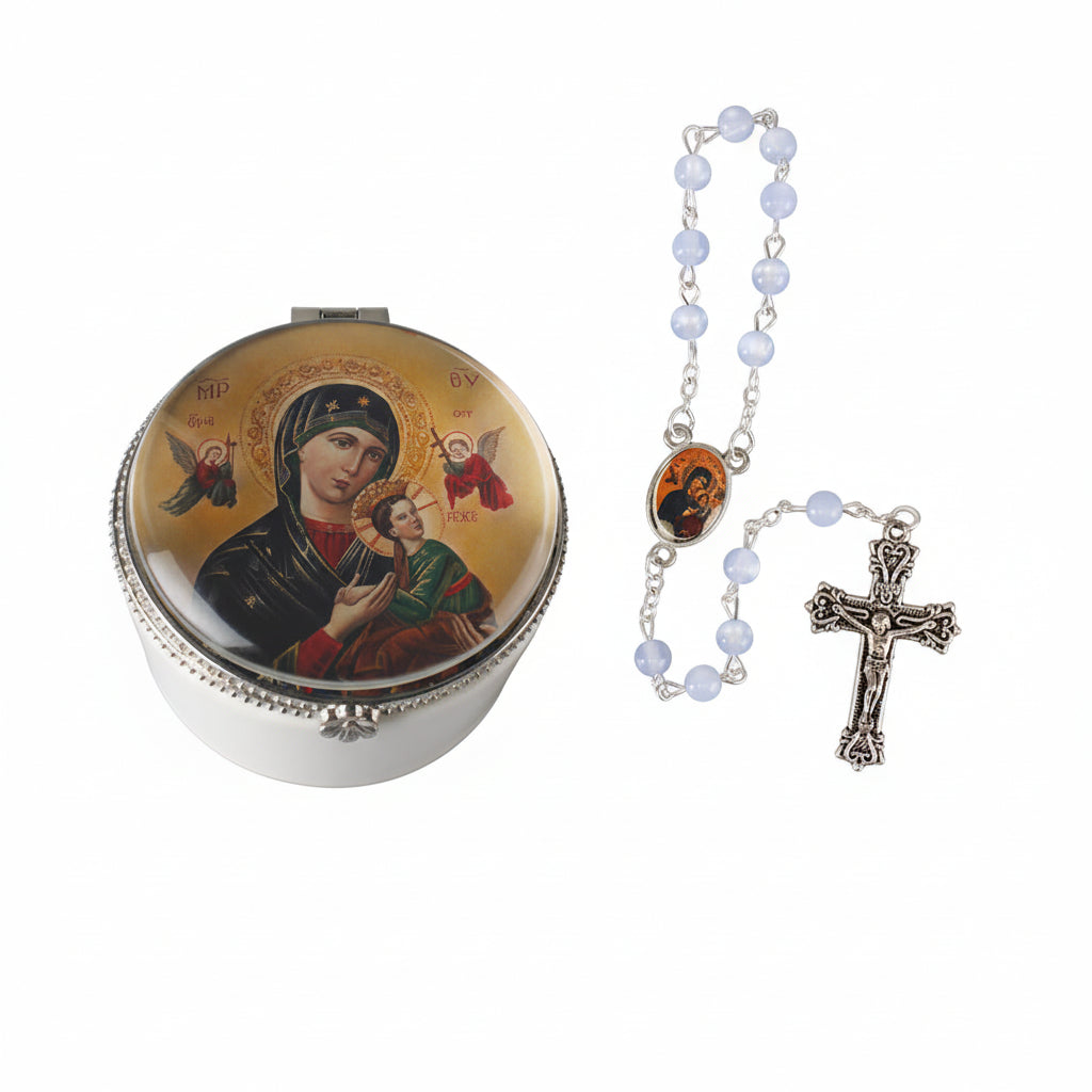 A porcelain rosary box with a picture glass dome lid featuring a black and red image of the Virgin Mary and child, accompanied by a metal cross and a strand of beads.