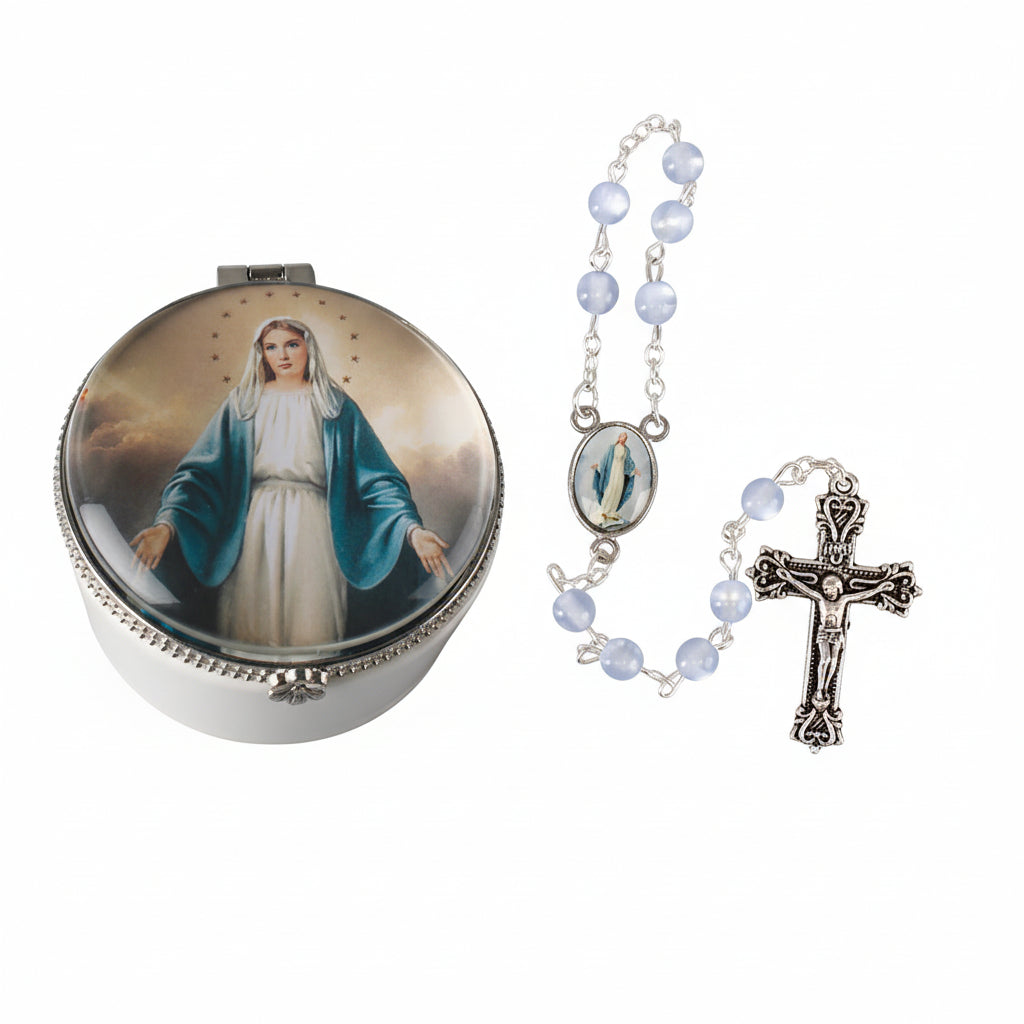 A porcelain rosary box with a picture of the Virgin Mary on the lid, a cross and a chain of beads on the right side, and a metal frame on the lid.