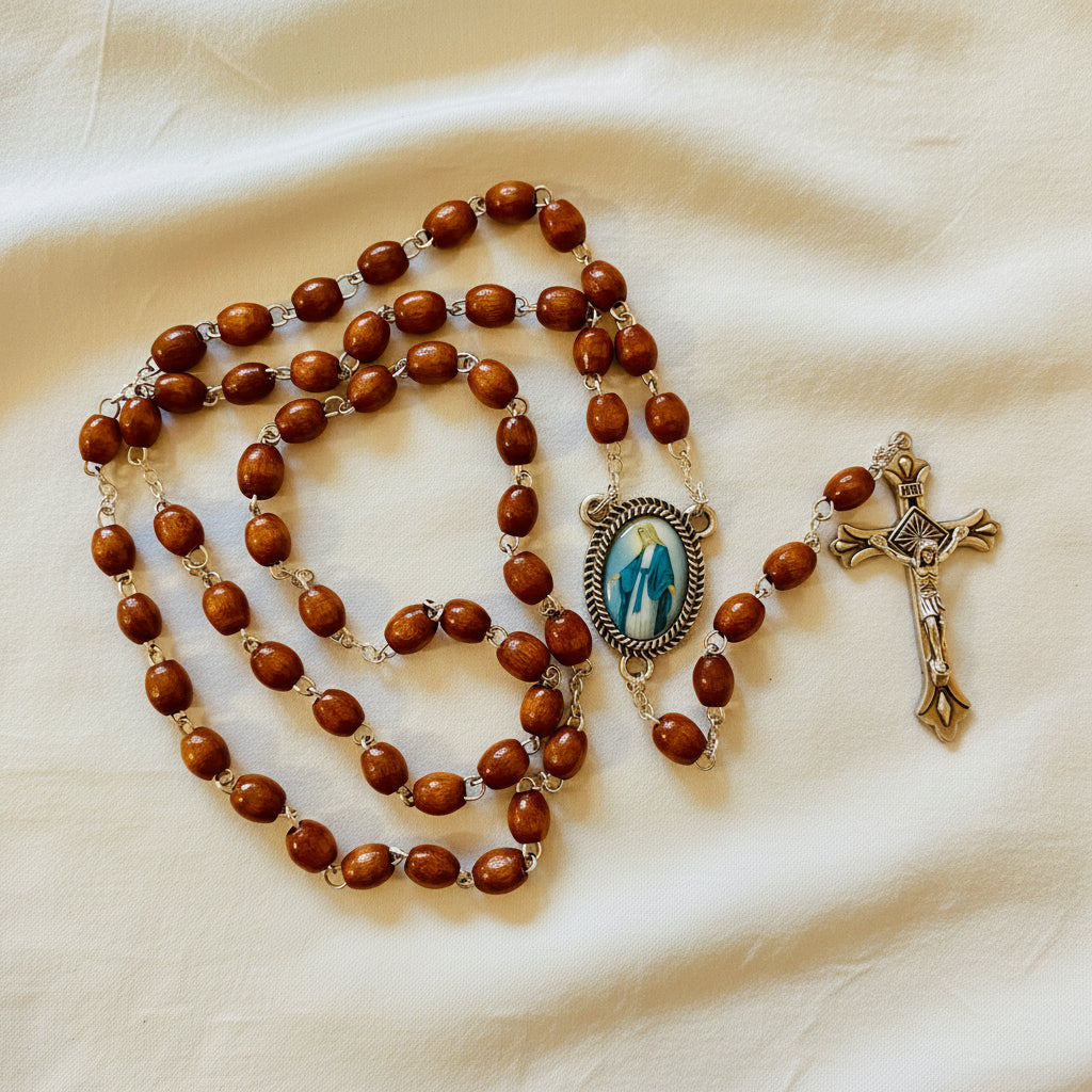 A brown wood rosary with a Miraculous Medal and a cross.