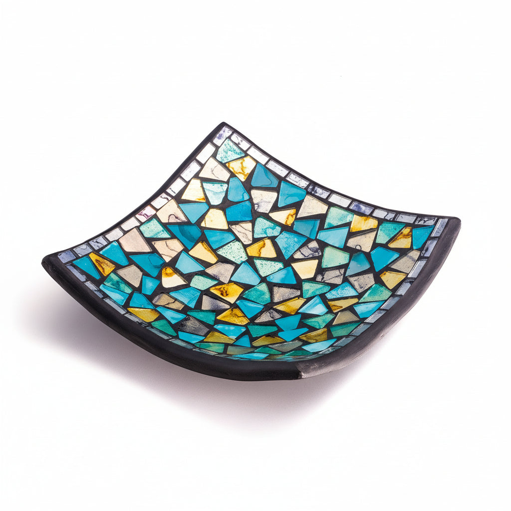 Mosaic glass bowl with blue and yellow pattern on a white background