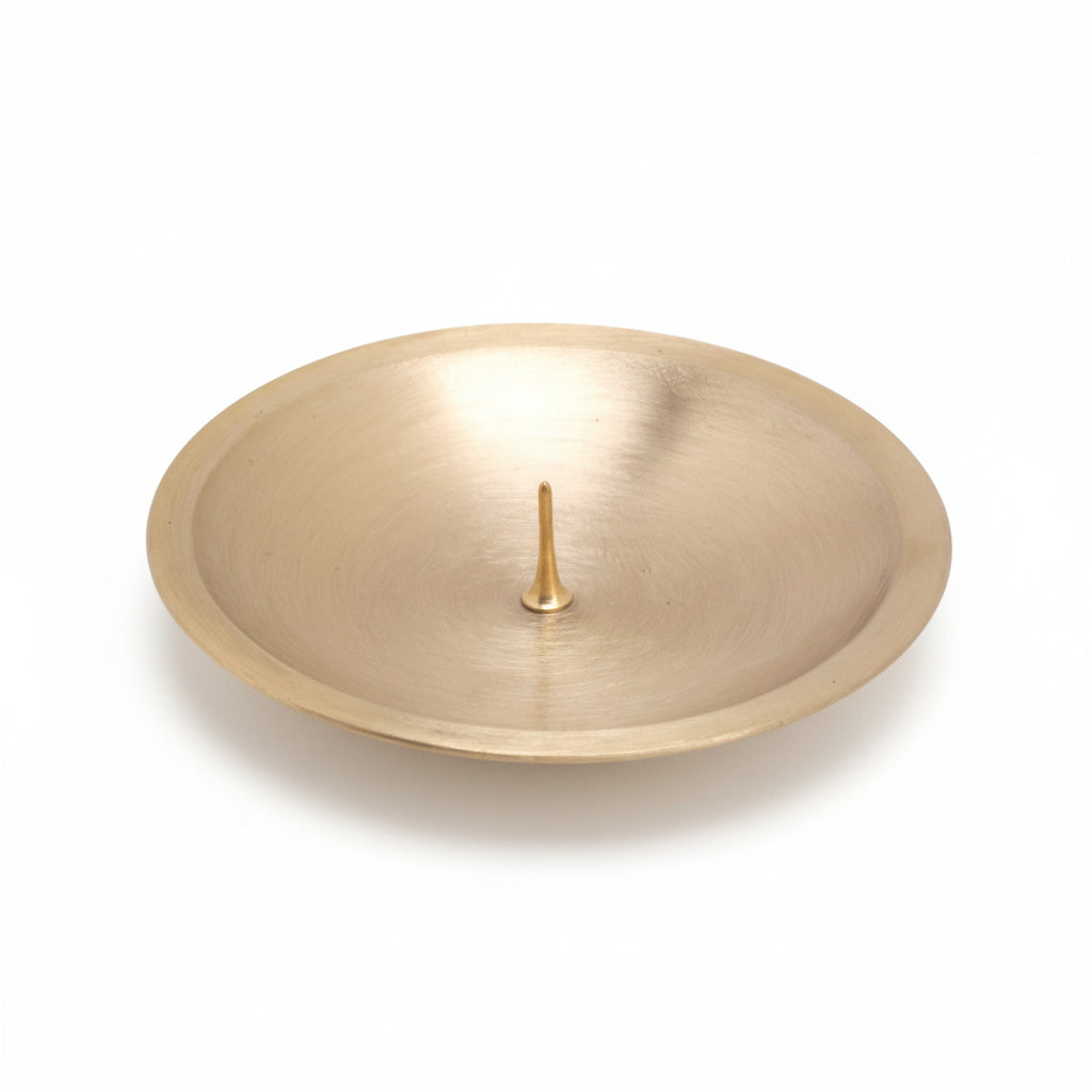 Gold circular object with a central spike on a white background