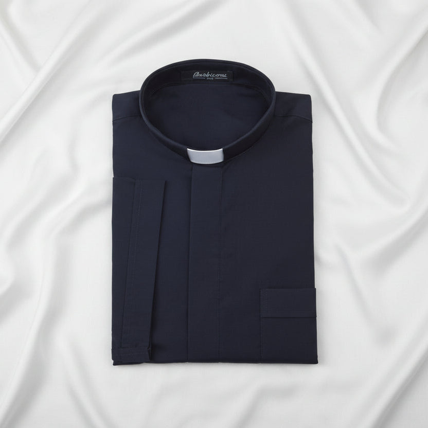 Folded navy blue clerical shirt with a collar on a white background