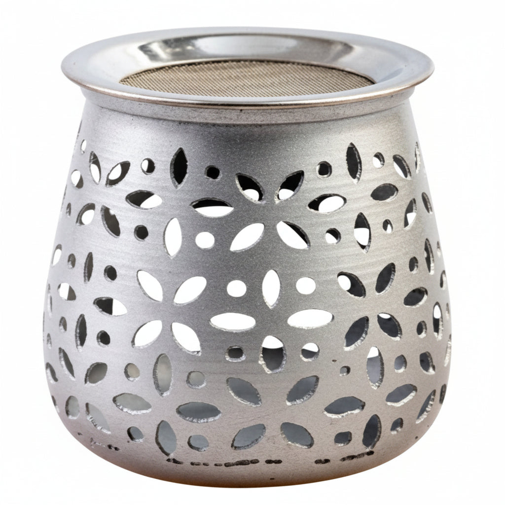 Silver metal lantern with floral cutout design on a white background
