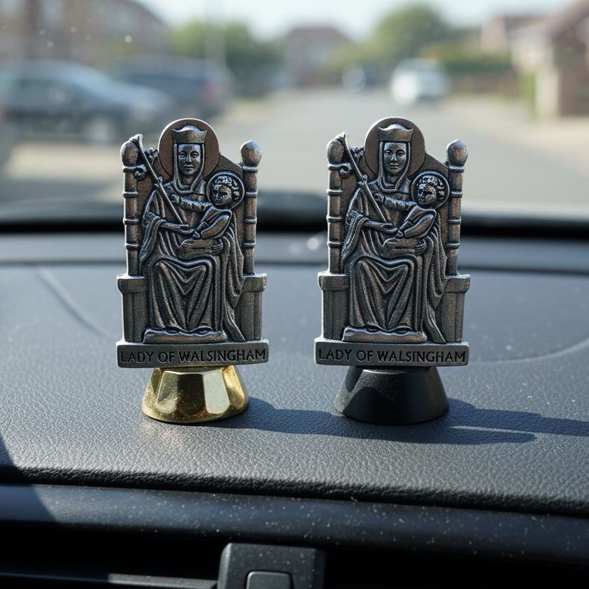 Two Lady of Walsingham figurines on stands against a white background