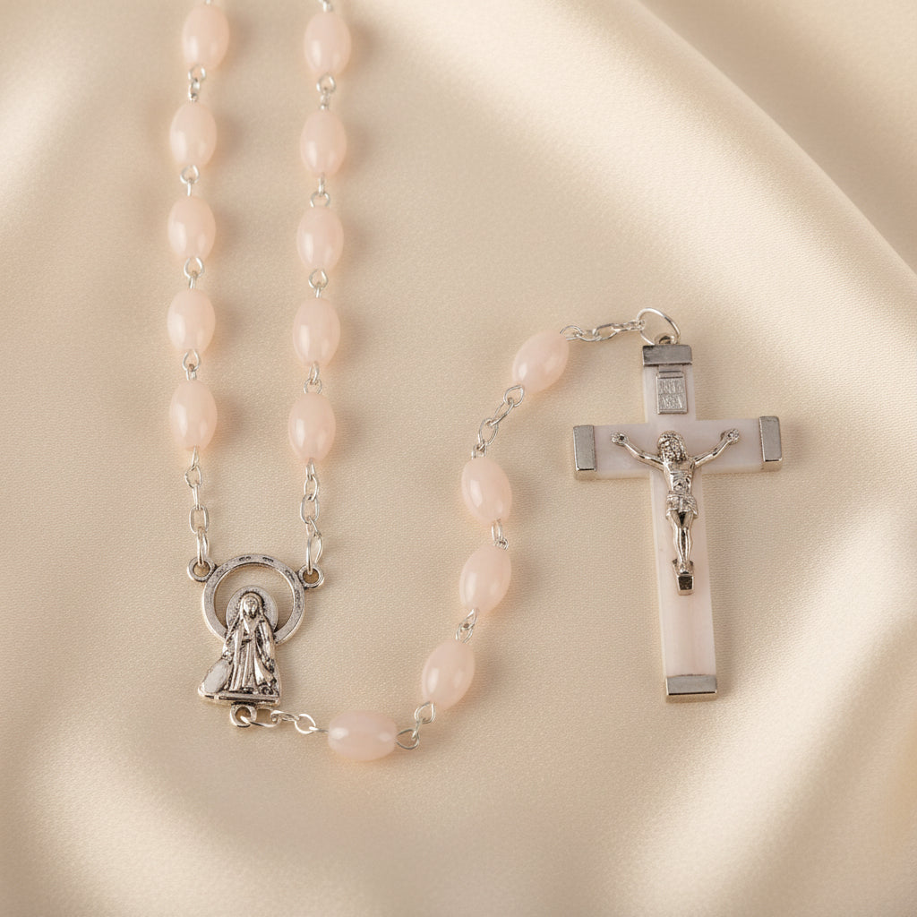 A Luminous Rosary with strong wired beads in pink, plastic oval beads, a luminous crucifix, and a metal Our Lady centerpiece.