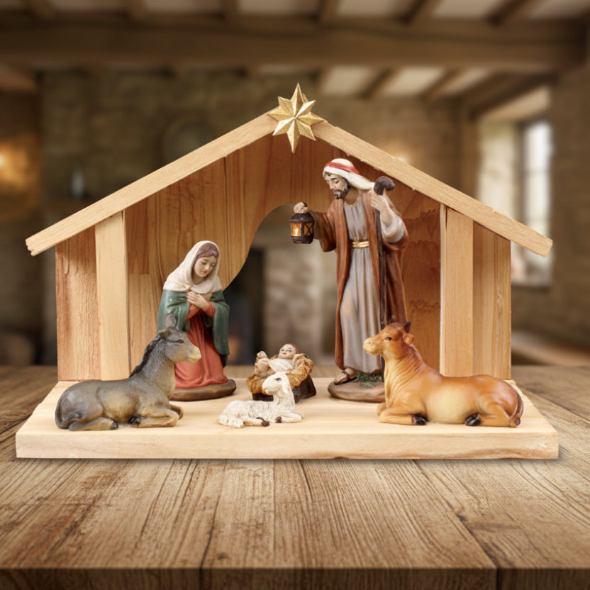 Wooden nativity scene with figures of Mary, Joseph, and animals on a white background