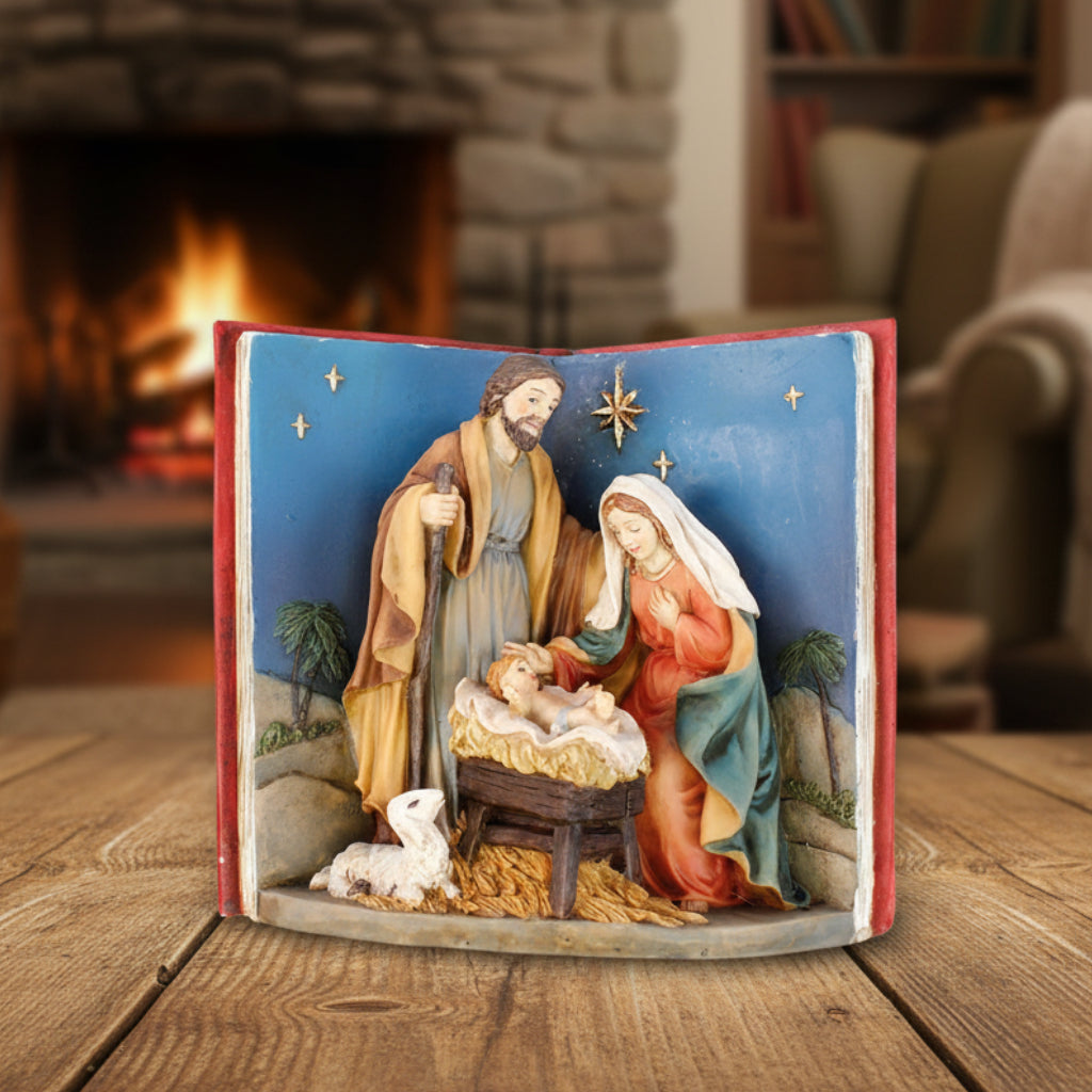 Decorative nativity scene with Mary, Joseph, and baby Jesus in a manger on an open book.