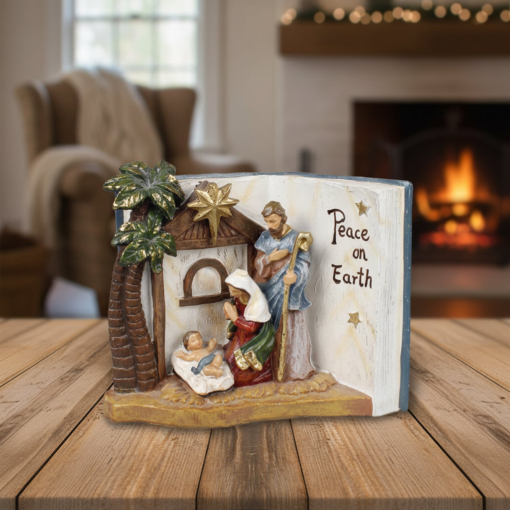 Nativity scene figurine with 'Peace on Earth' text on an open book