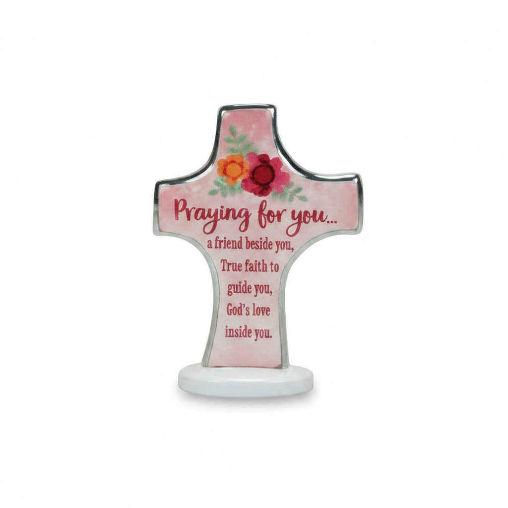 A decorative cross-shaped sign with the words 'BEDTIME PRAYERS' at the top and a prayer printed on the front, shown against a textured tan background.