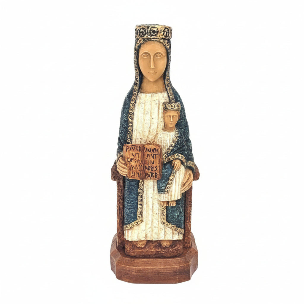 Statue of a religious figure holding a child on a wooden base