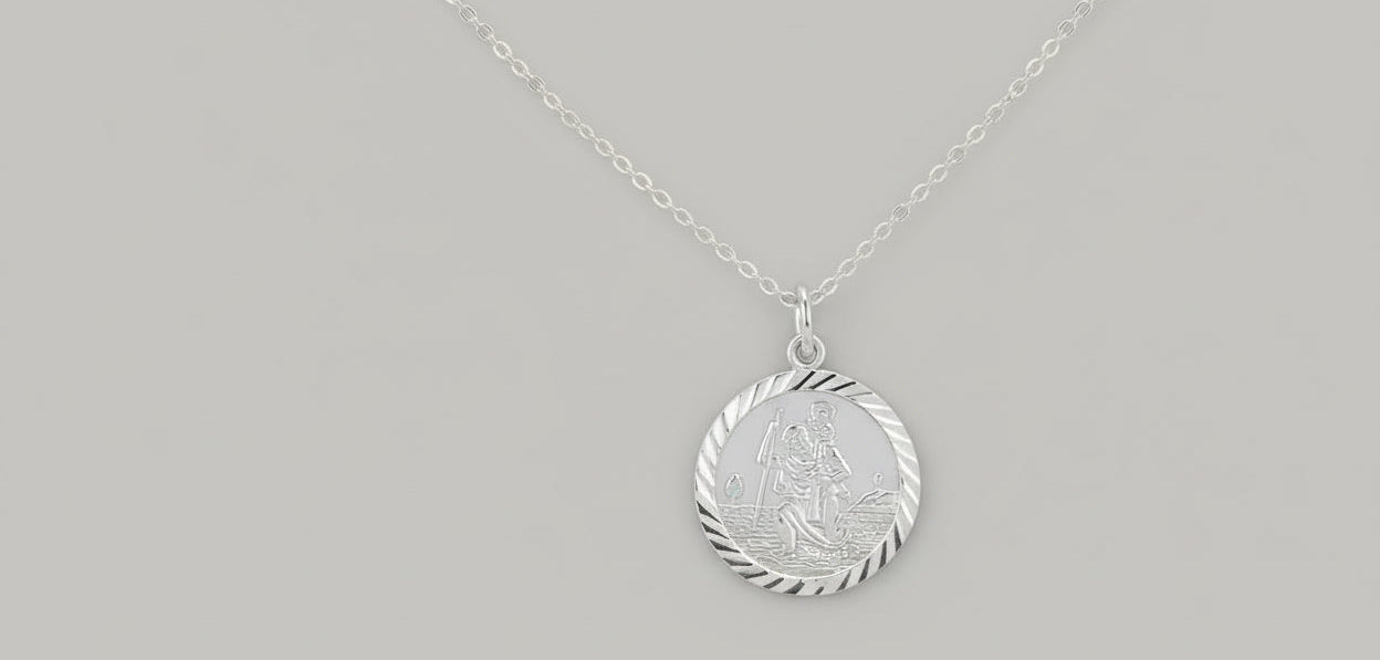 Silver pendant with a detailed design of saint christopher