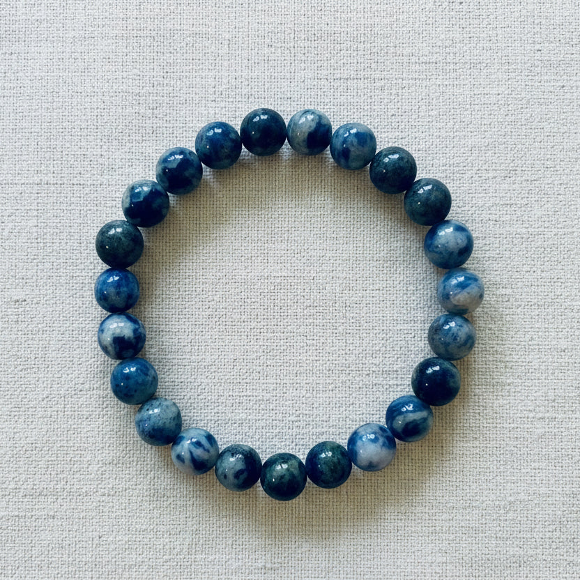 A sodalite bracelet with blue and white stones, packaged on a card that reads 'POWER BRACELETS' and 'SODALITE Truth & Clear Thinking'.