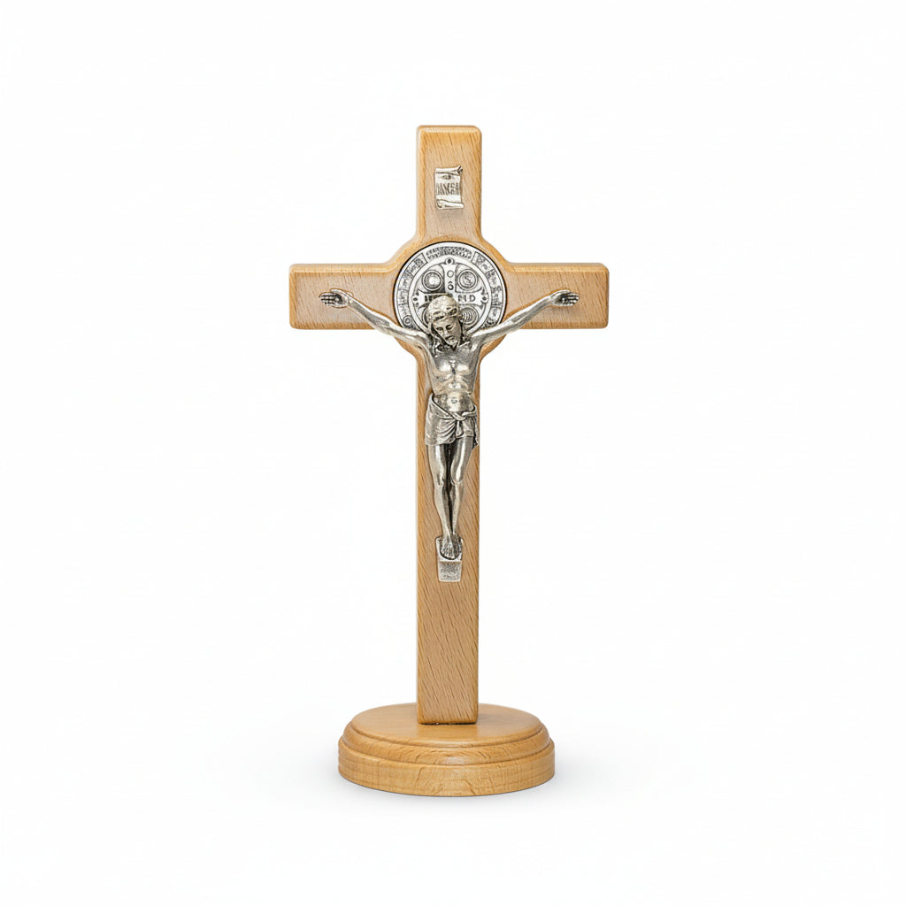 Wooden cross with silver Jesus figure on a white background