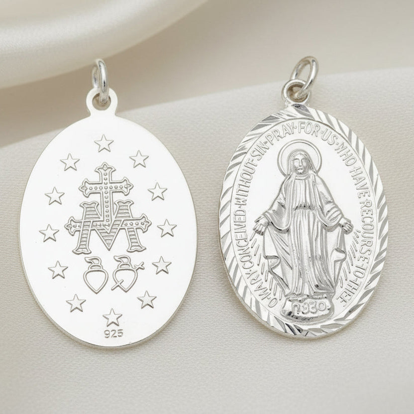 Two silver religious medallions on a white background