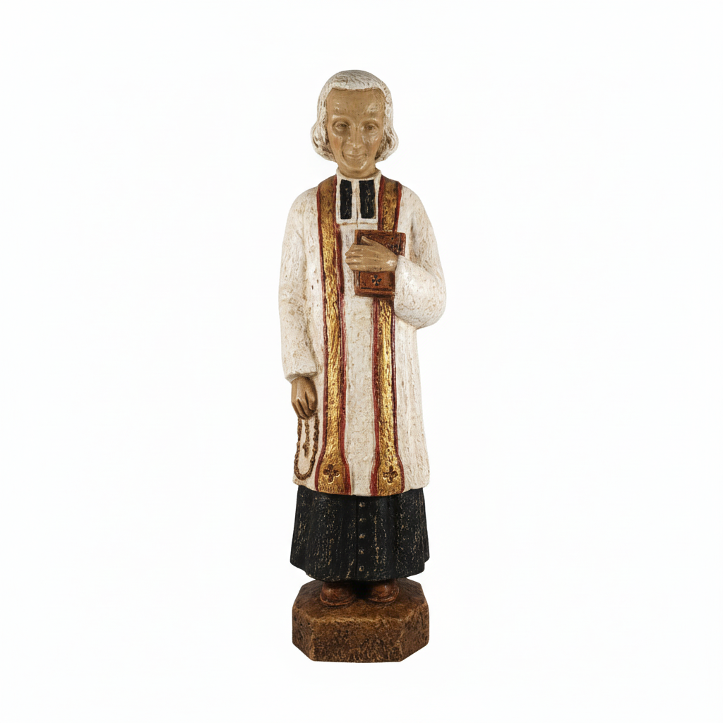 A statue of a priest wearing a white robe with brown stripes and a black cassock, standing on a wooden base.
